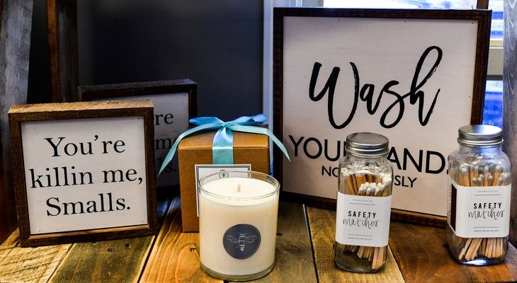 Gift shop display with signs and candles