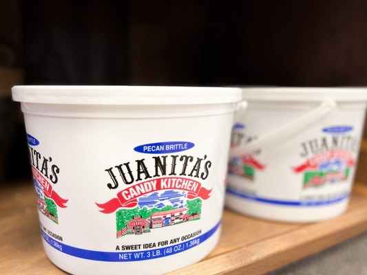 Juanita's Candy Kitchen tub labeled pecan brittle